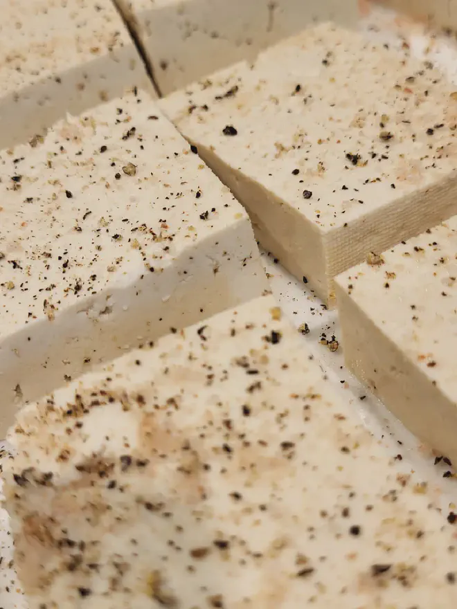 Easy baked tofu pieces on a white plate.